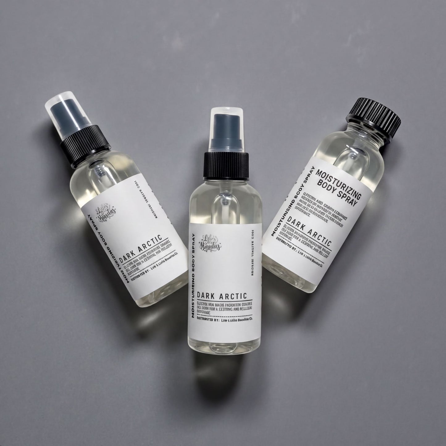 Three bottles of dark arctic body spray are arranged on a gray background.