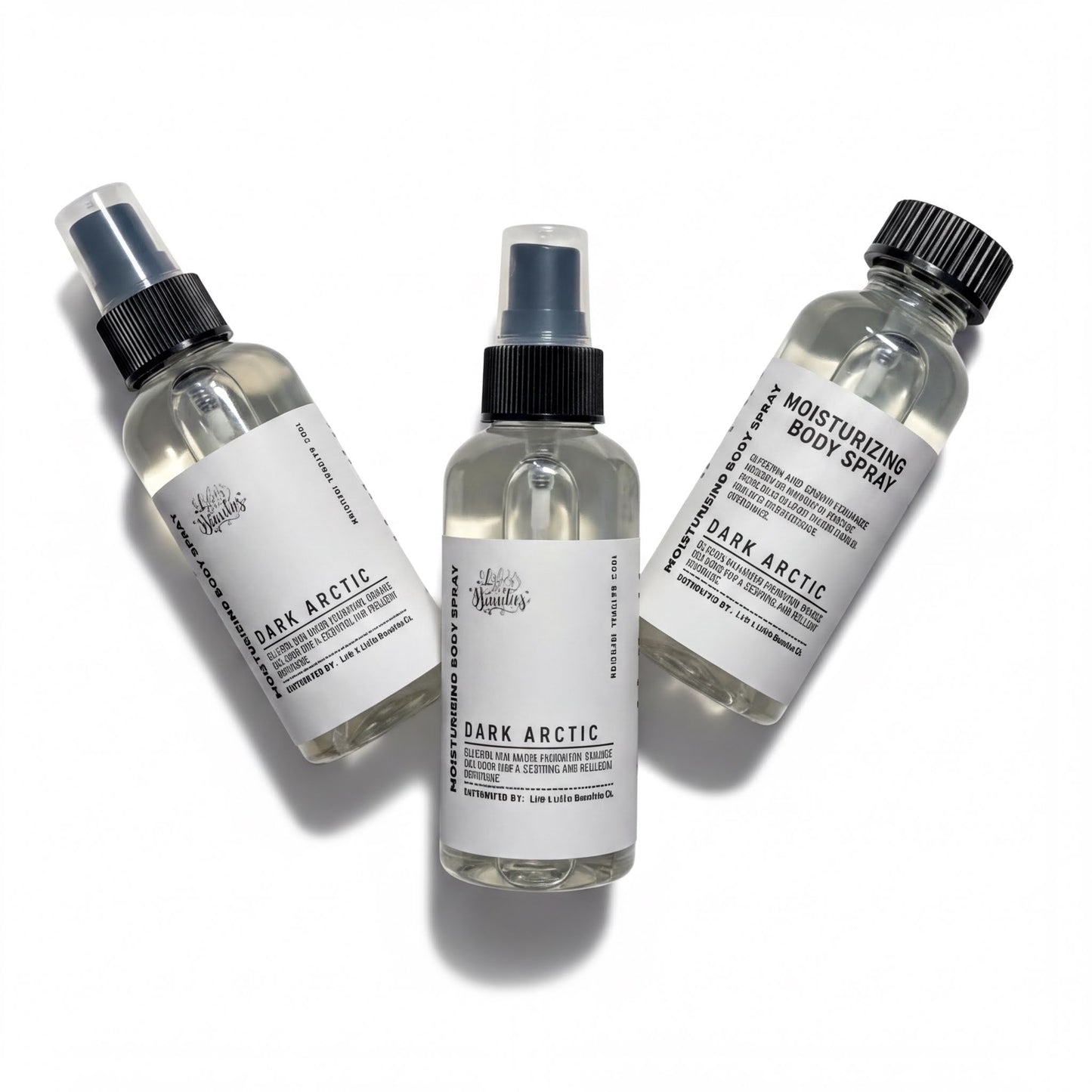 Three bottles of body spray with black caps and white labels, each containing a different scent.