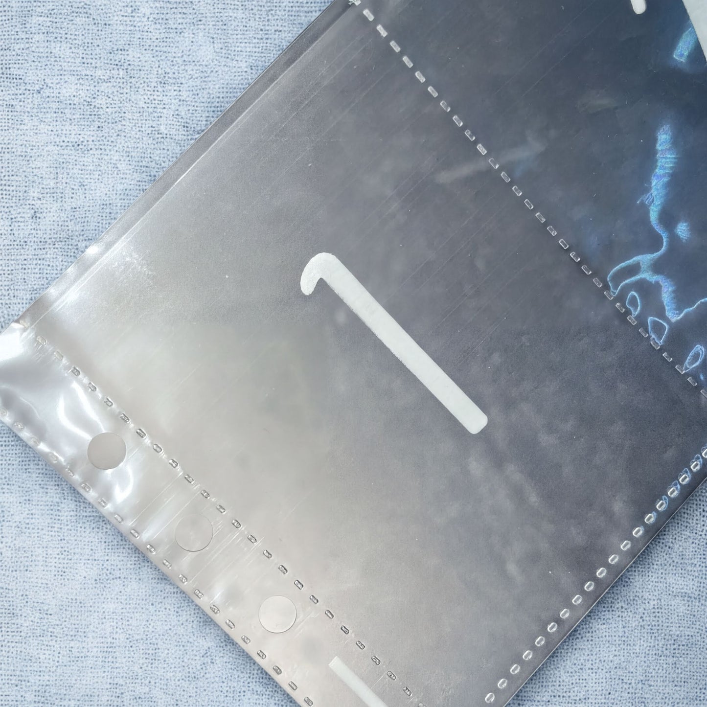 a close-up view of a metallic surface with a white number 1 visible on it.