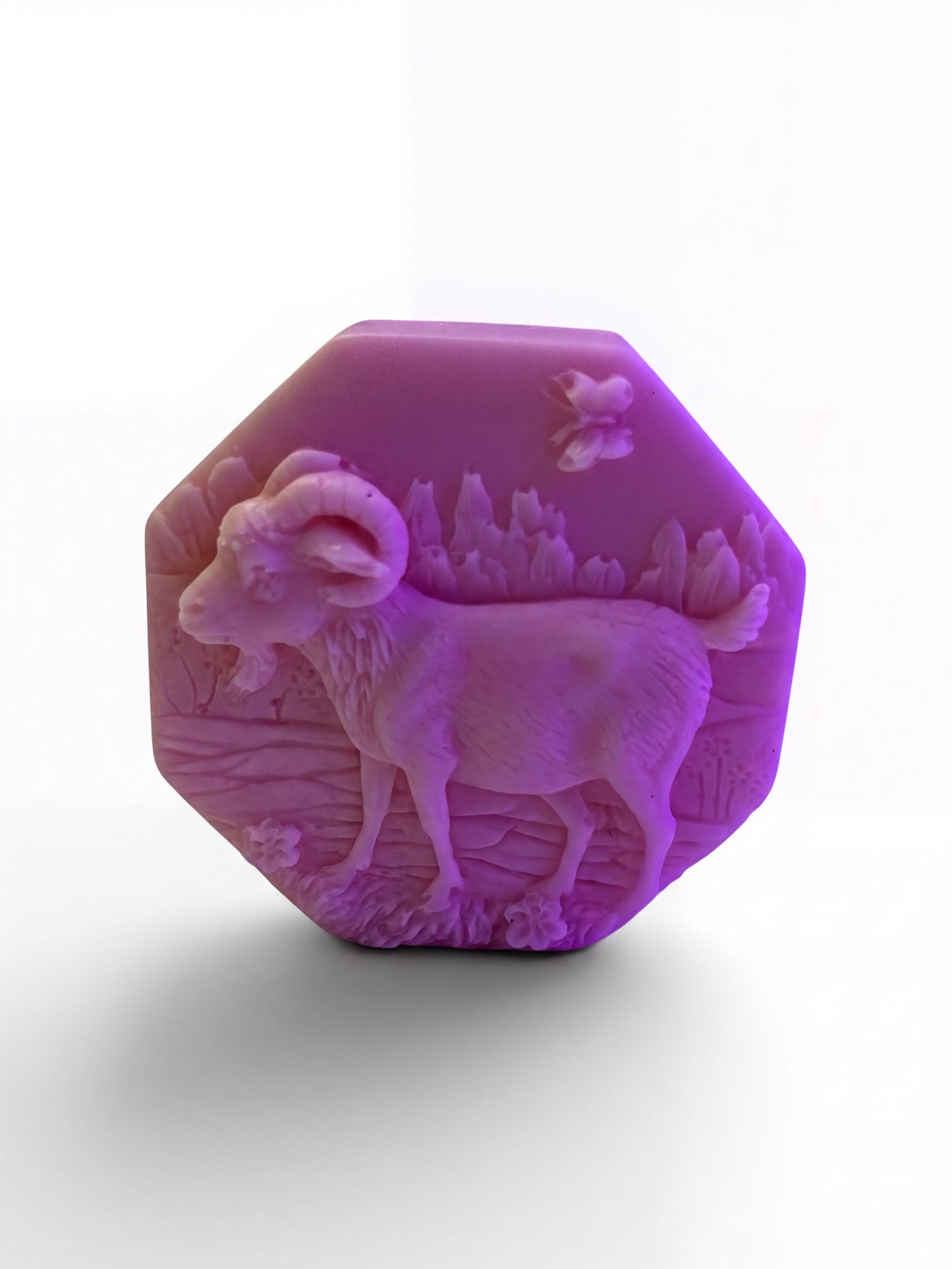 a purple soap bar with an embossed design of a goat on it.