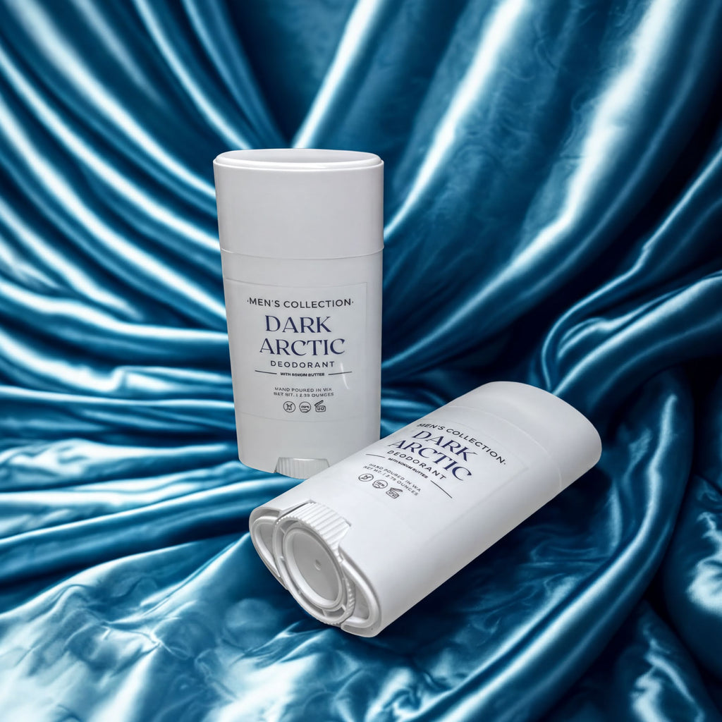 Two white deodorant sticks from Men's Collection Dark Arctic are shown against a blue fabric background.