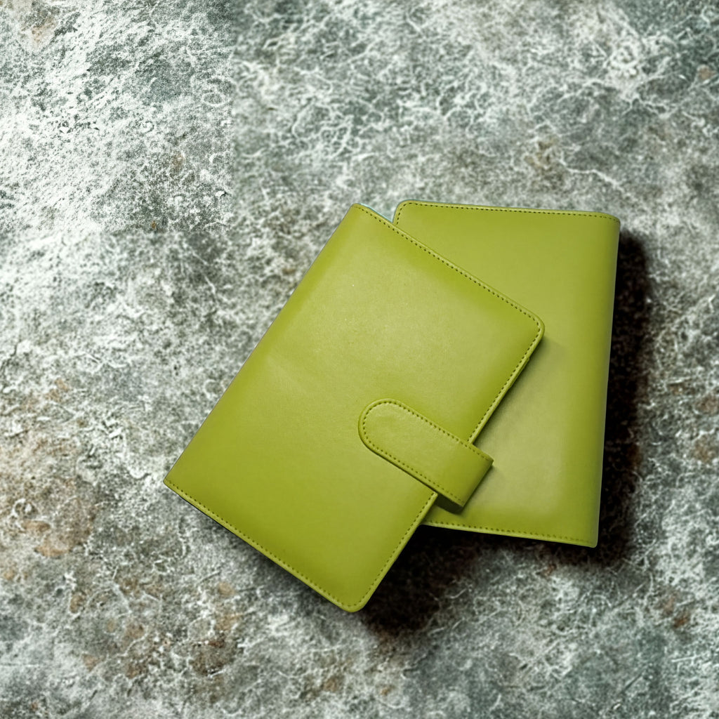 Lime green leather wallet with strap closure on textured stone surface