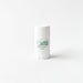 A white deodorant stick with green text and a green design on it.