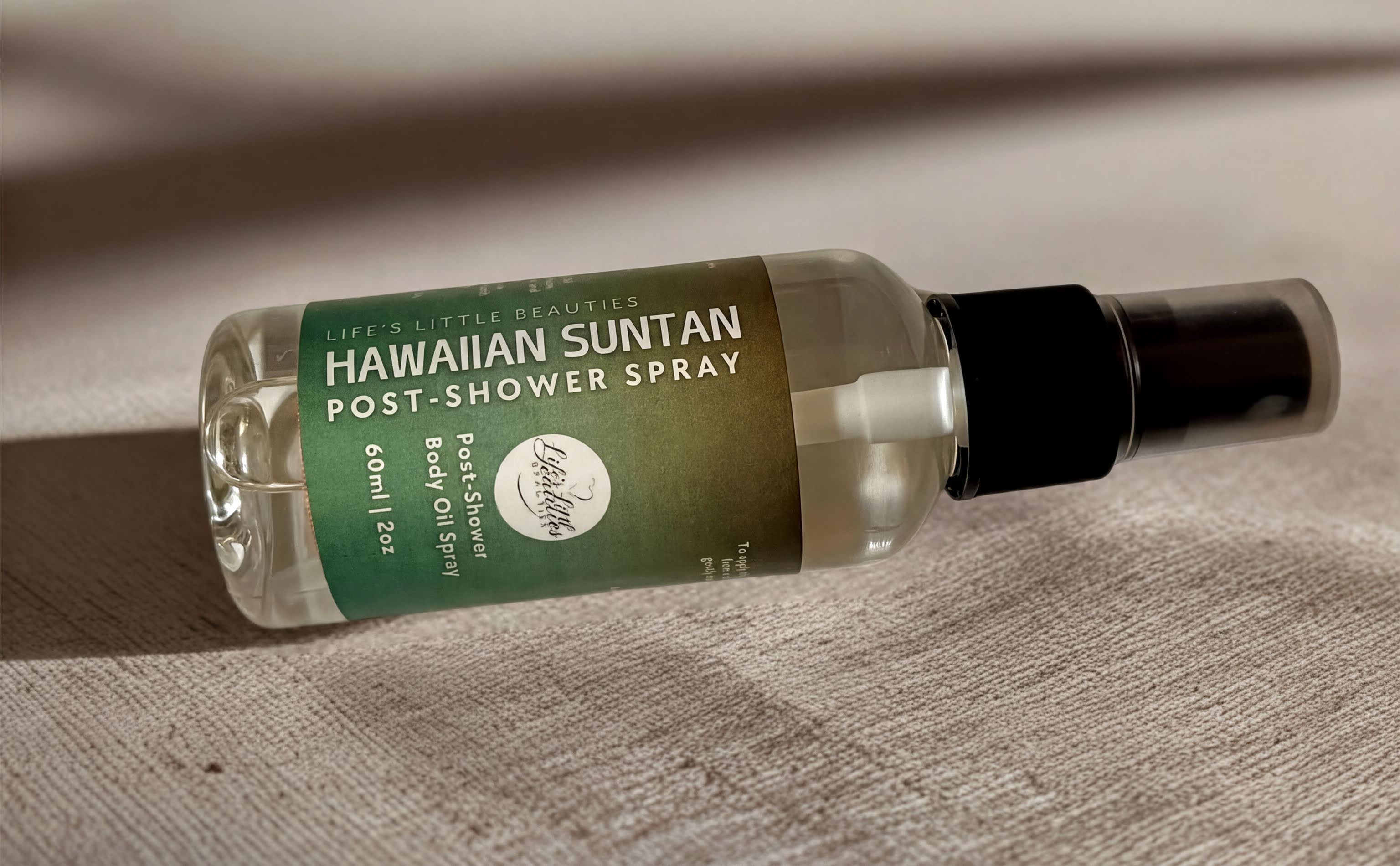 A bottle of Hawaiian sunscreen body oil spray is shown on a textured surface.