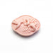 A pink soap with a bird and flower design on it.