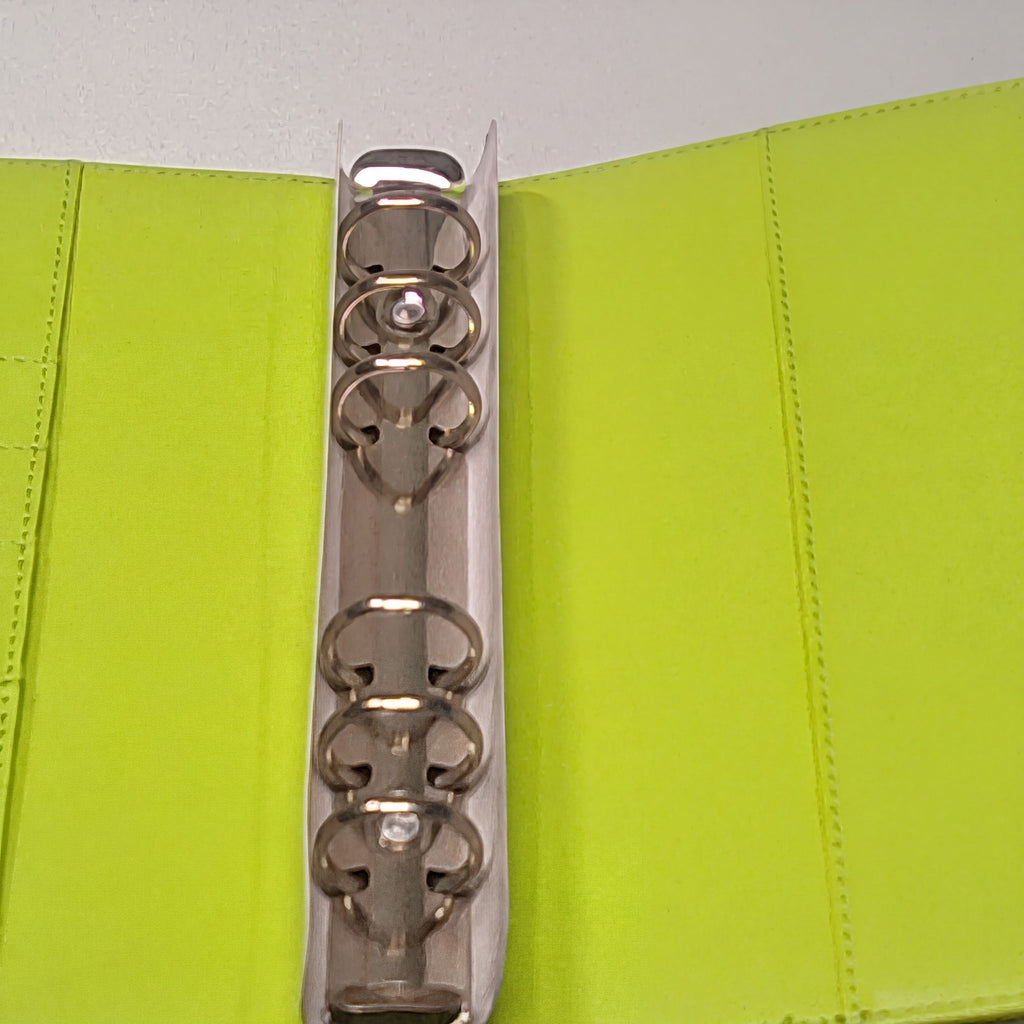 Lime green fabric binder with silver metal rings and stitching detail