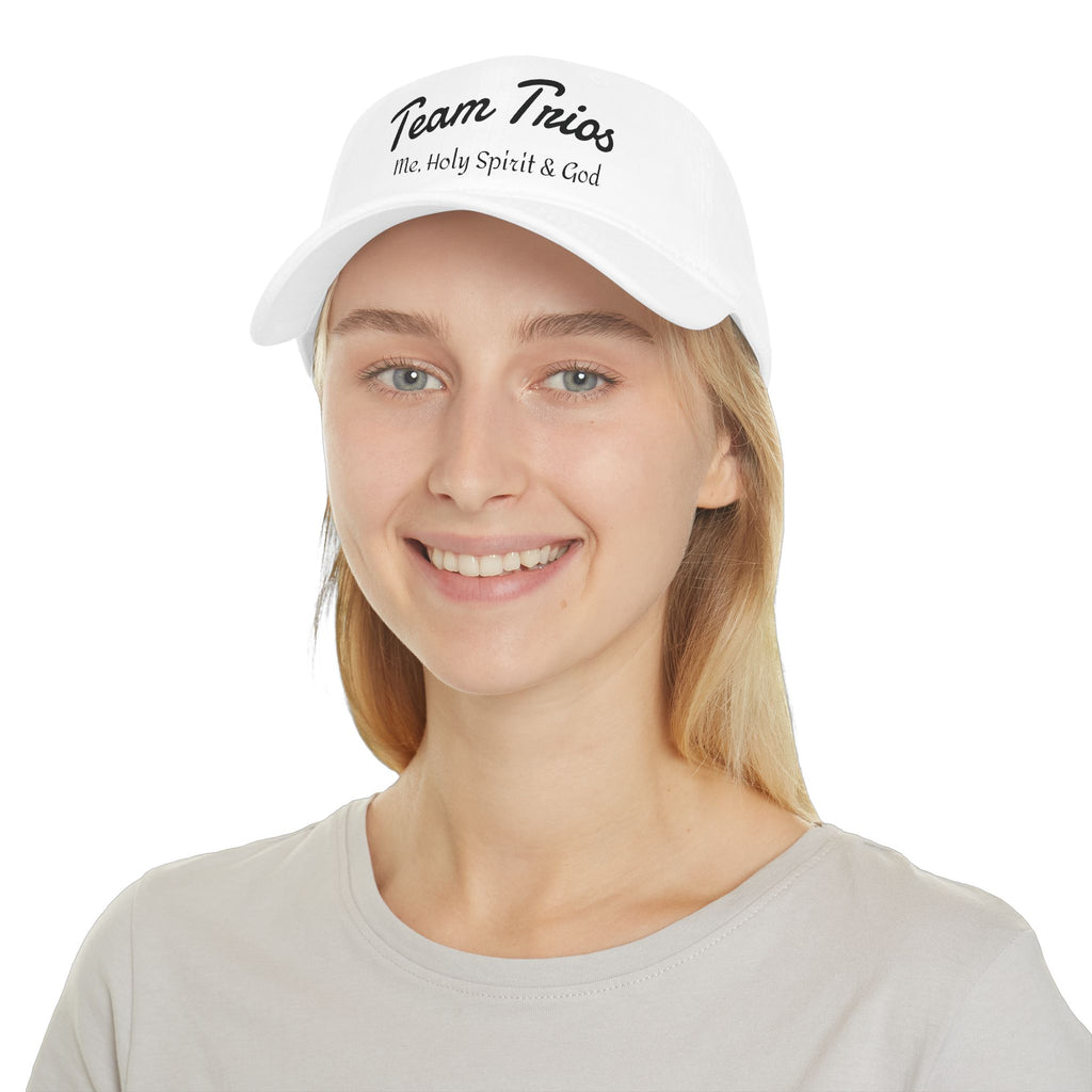 White cap with 'Team Trios Me, Holy Spirit & God' text, worn by smiling woman