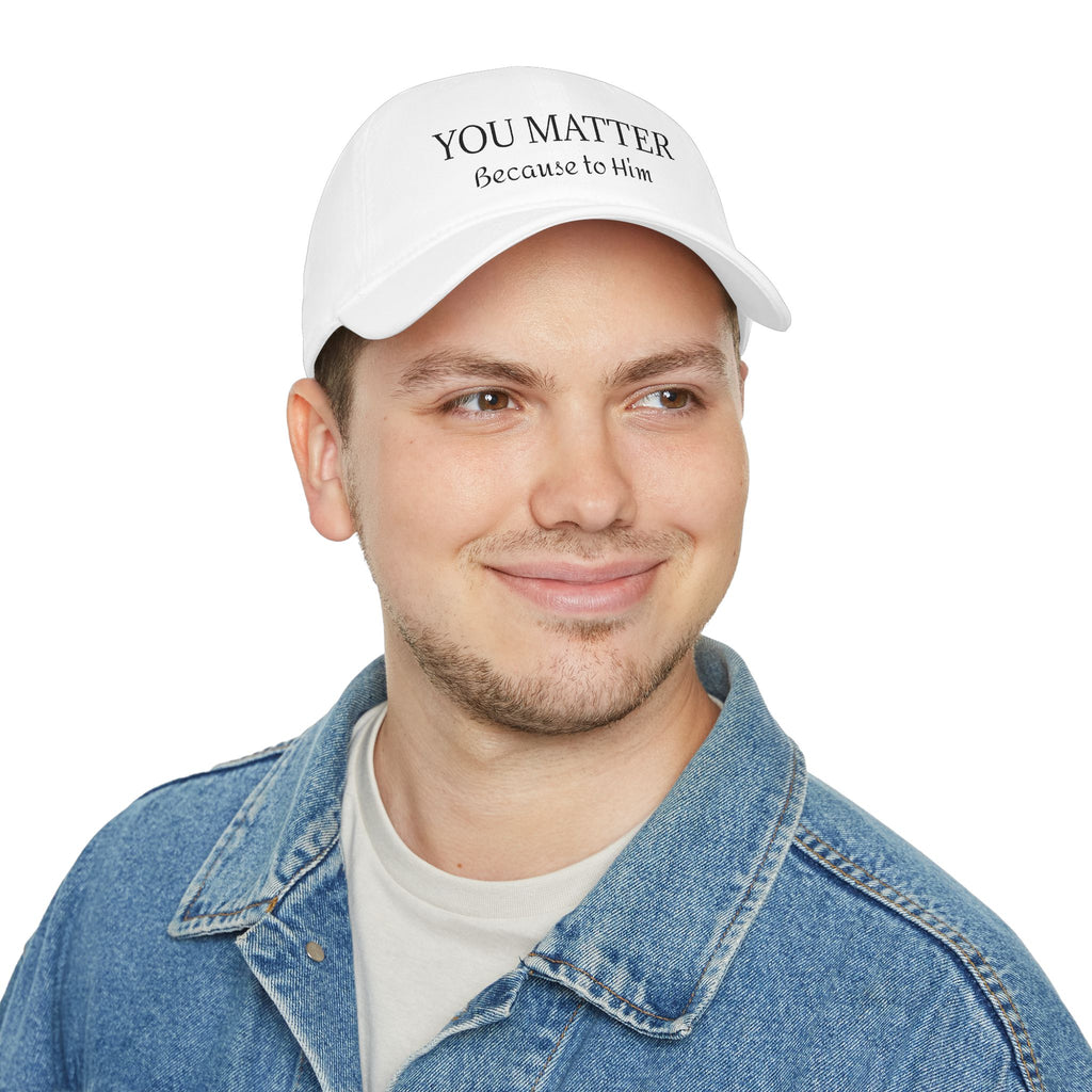 White cap with 'YOU MATTER Because to Him' text, worn by man in denim jacket
