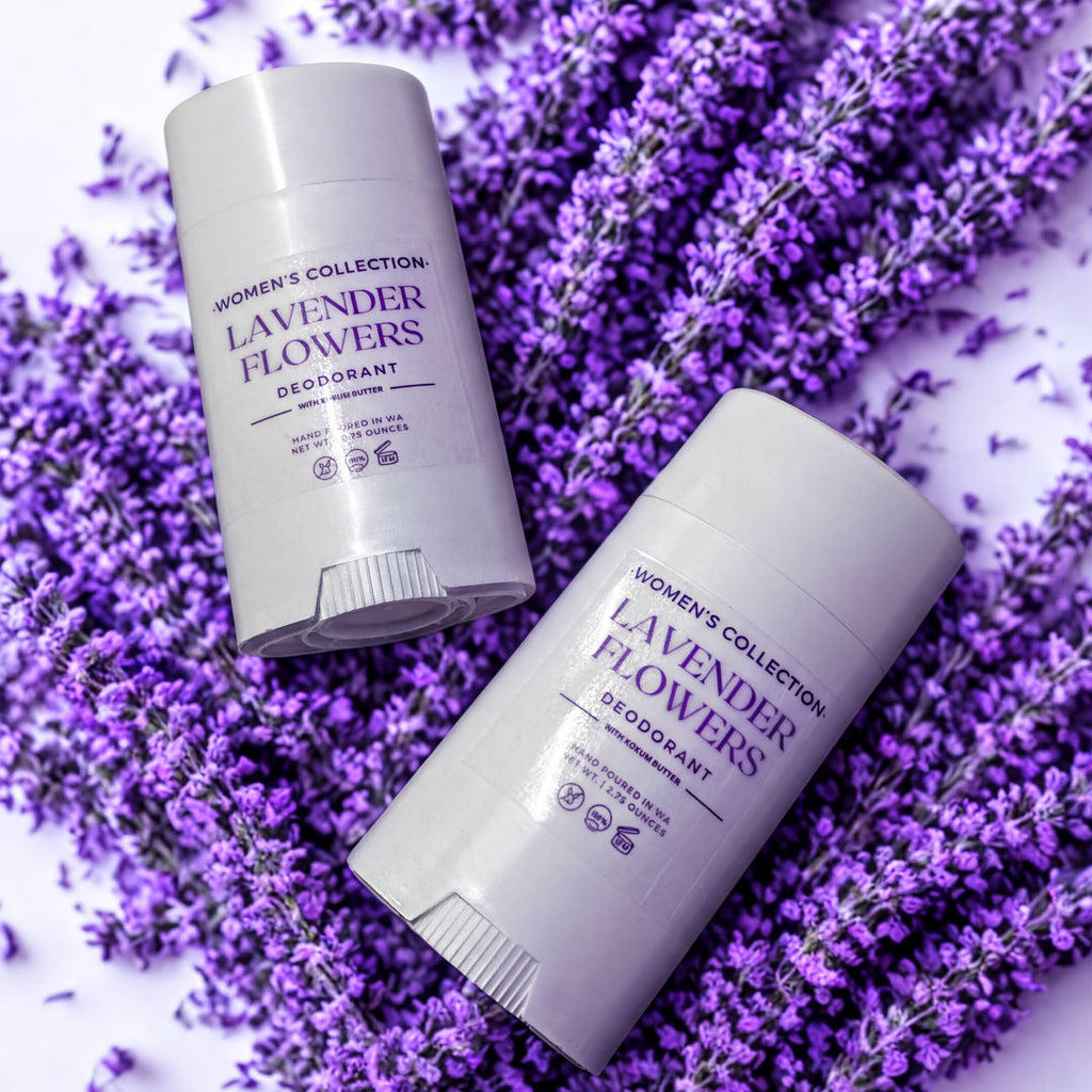 Two deodorant sticks from the Women's Collection are placed on a bed of purple lavender flowers.