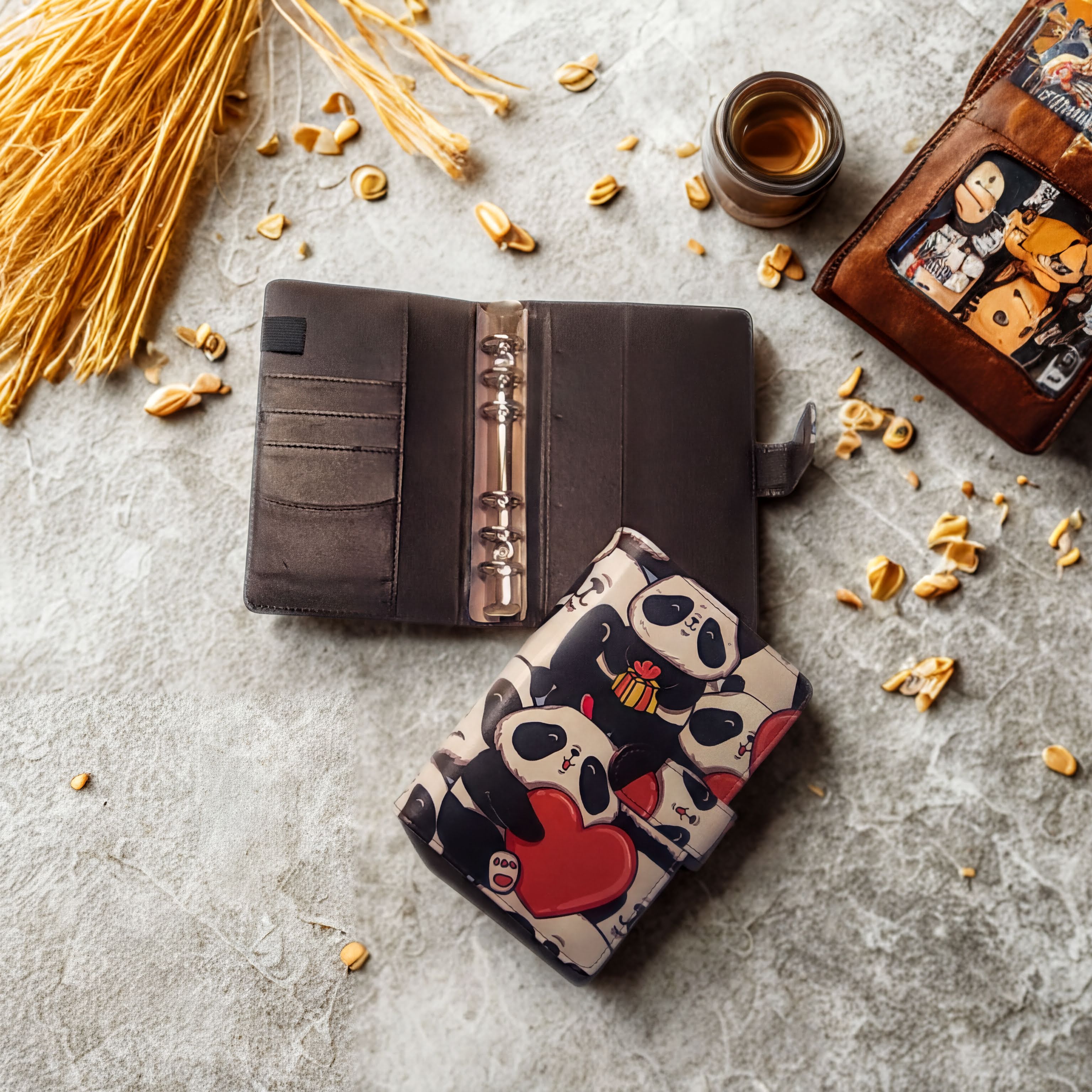Cute panda-themed planner with heart design, open on textured surface with dried wheat and coffee