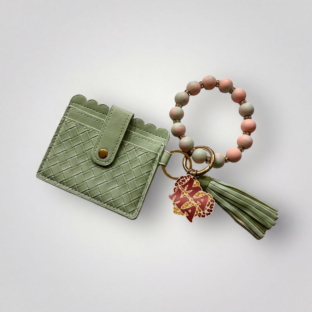 A green woven wallet and a beaded bracelet are displayed against a white background.