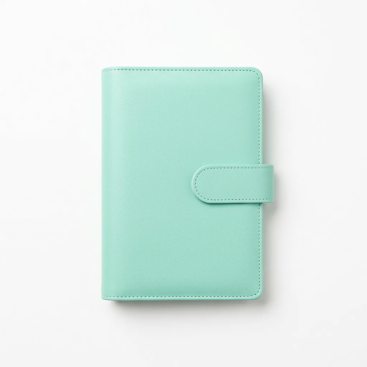 A mint green leather-bound notebook or planner with a small leather clasp on the front.