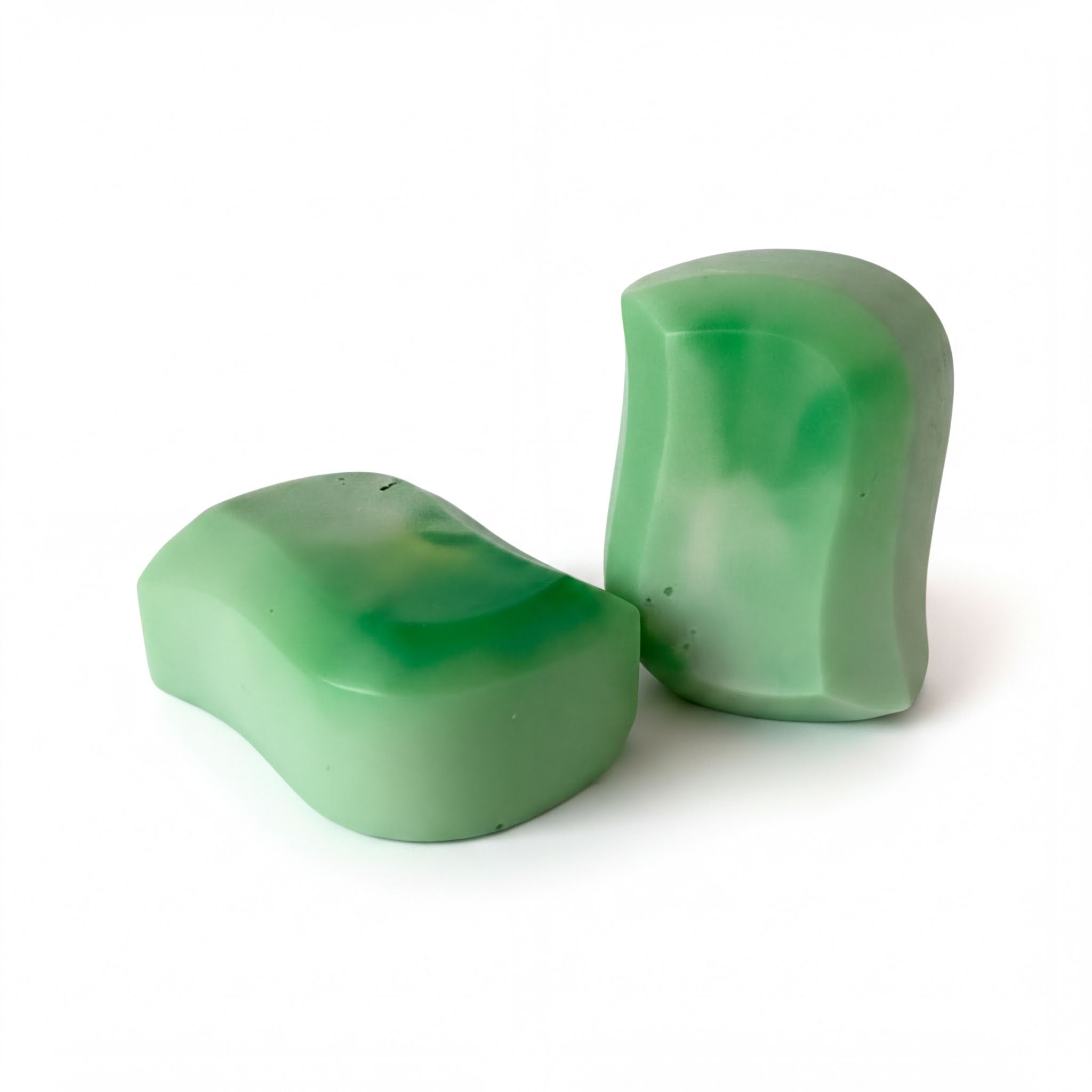 Two green, wavy soap bars are shown against a white background.