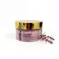 A jar of lavender-scented bath salt with a gold lid, surrounded by scattered lavender flowers.