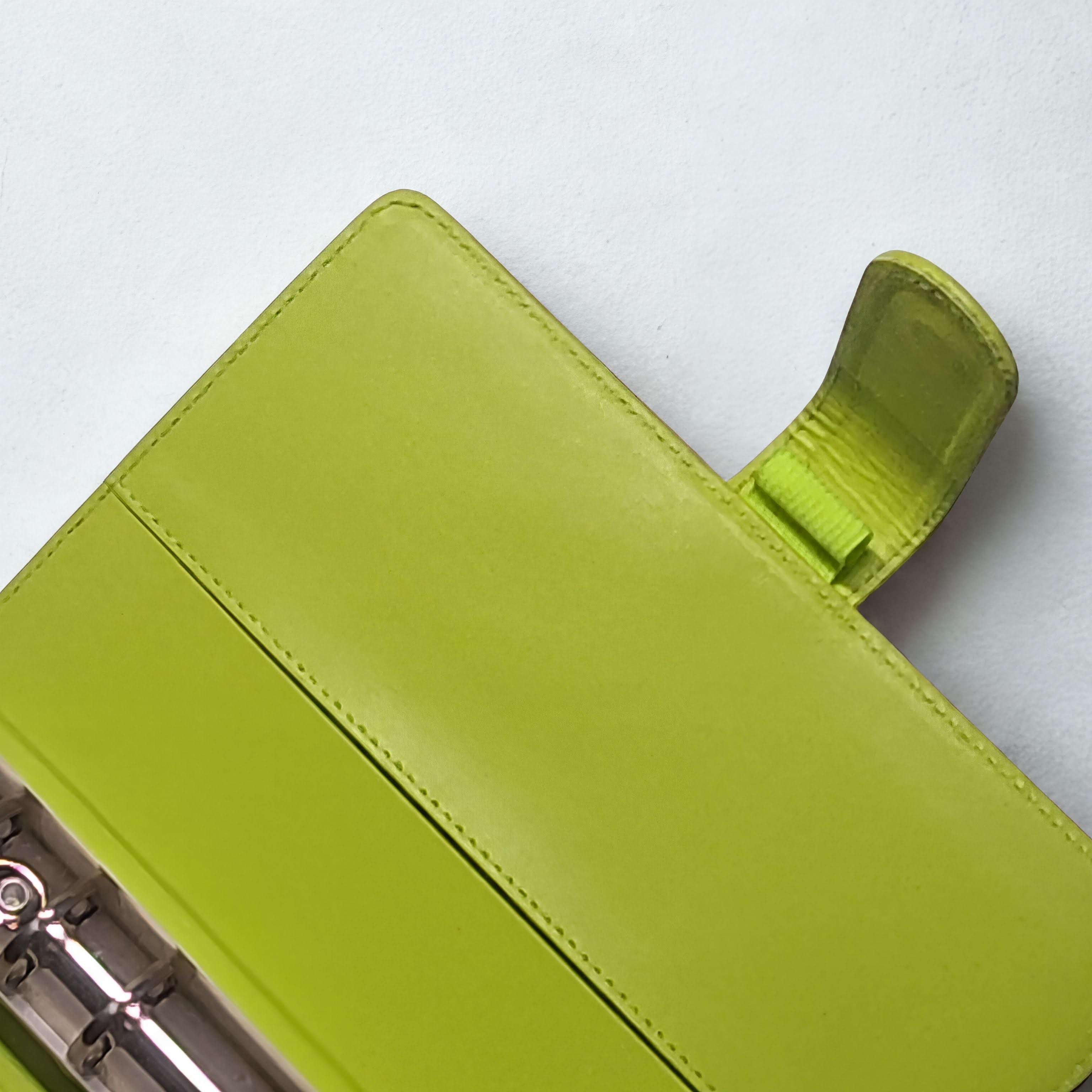 Lime green leather notebook cover with snap closure and stitching detail