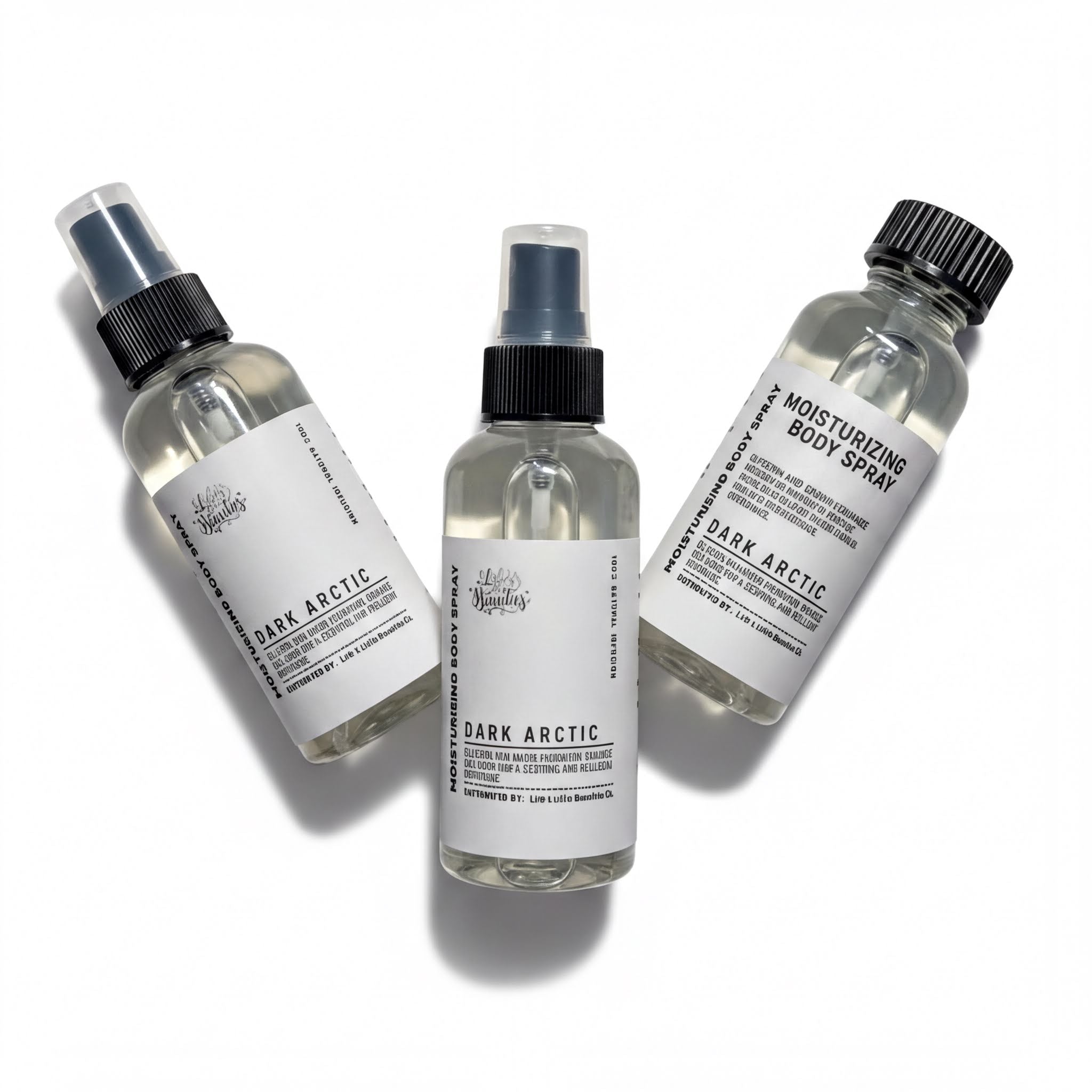 Three bottles of body spray with black caps and white labels, each containing a different scent.