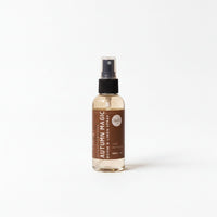 A bottle of "Autumn Magic" room spray is shown against a white background.
