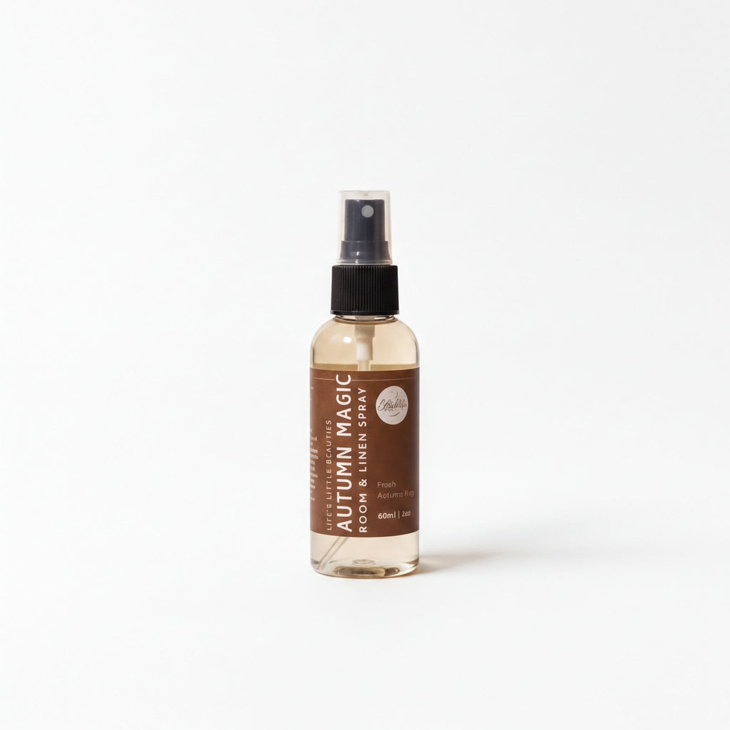 A bottle of "Autumn Magic" room spray is shown against a white background.