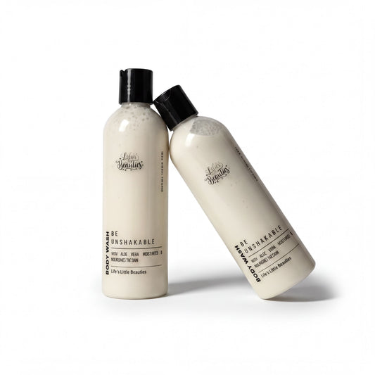 A bottle of body wash with a white label that reads "Be Unbreakable" and "Body Wash with Aloe Vera, Nourishing & Nourishing The Skin".