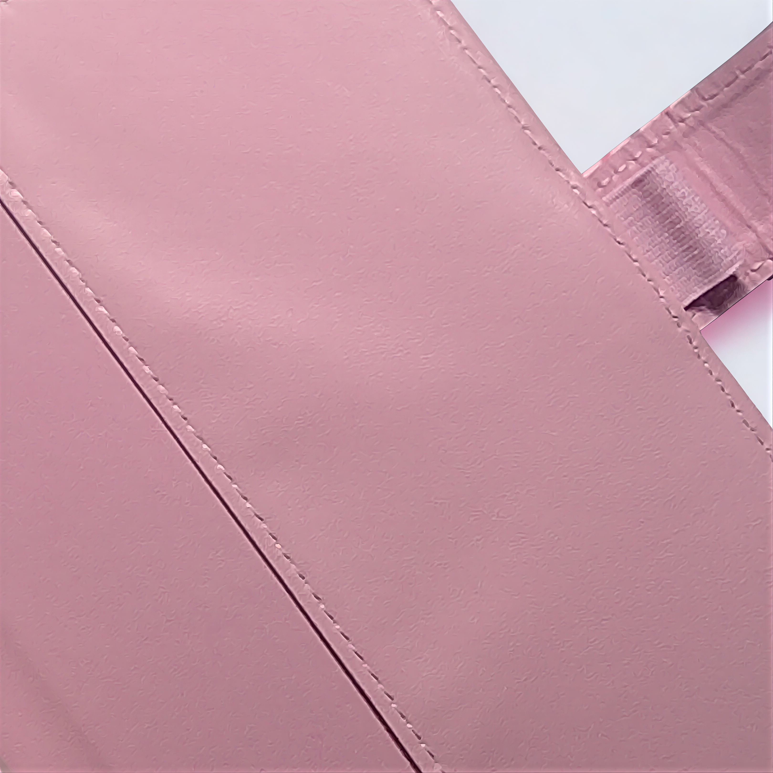 Pink textured soap bar with visible stitching, handcrafted with natural ingredients