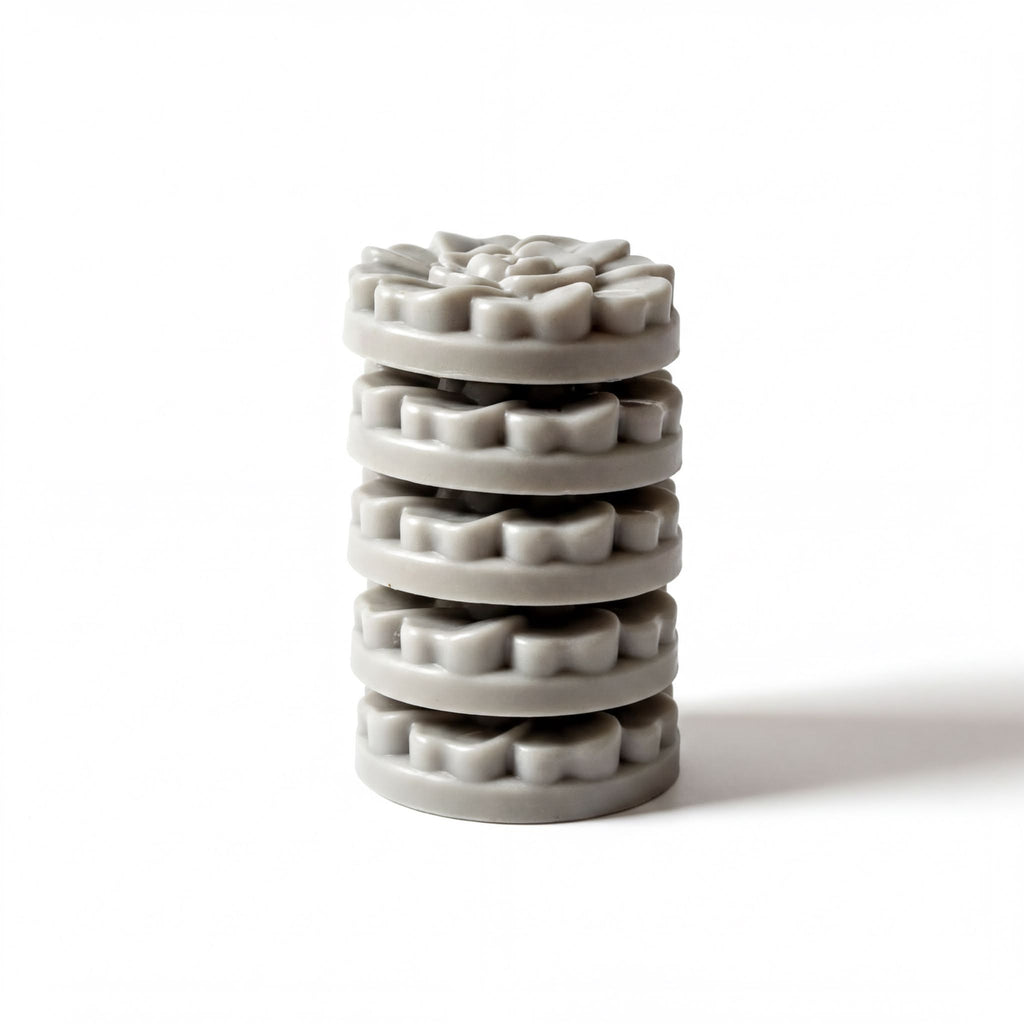 A stack of gray, circular objects arranged in a pyramid-like structure against a white background.