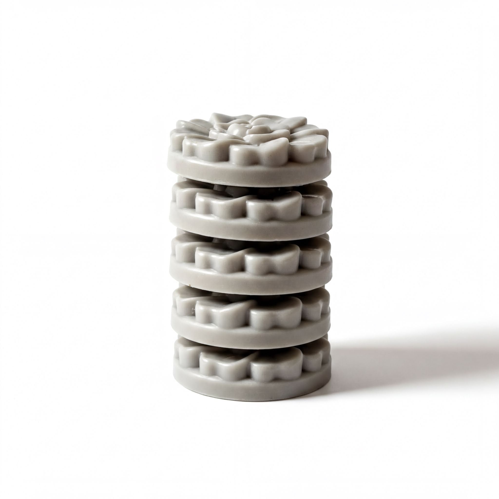 A stack of gray, circular objects arranged in a pyramid-like structure against a white background.
