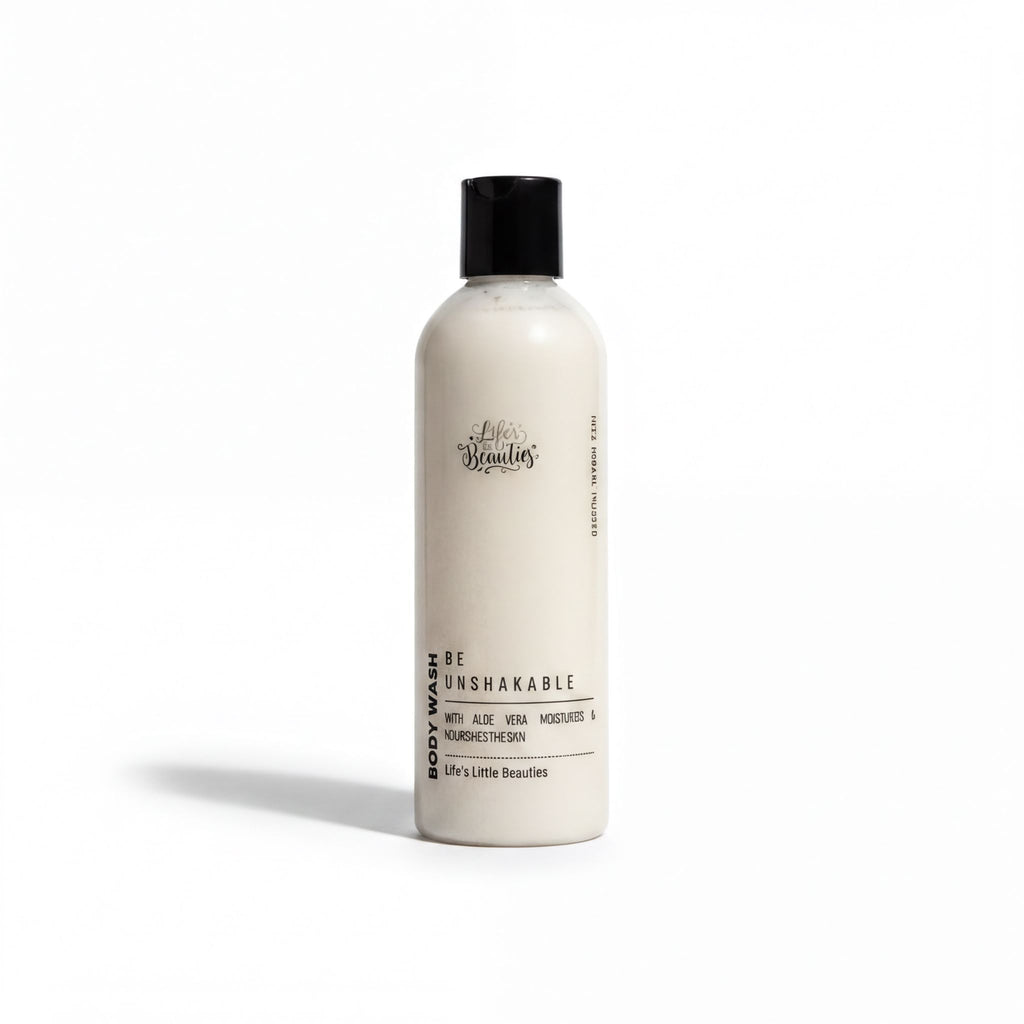 A bottle of body wash with a white label that reads "Be Unbreakable" and "Body Wash with Aloe Vera, Nourishing & Nourishing The Skin".