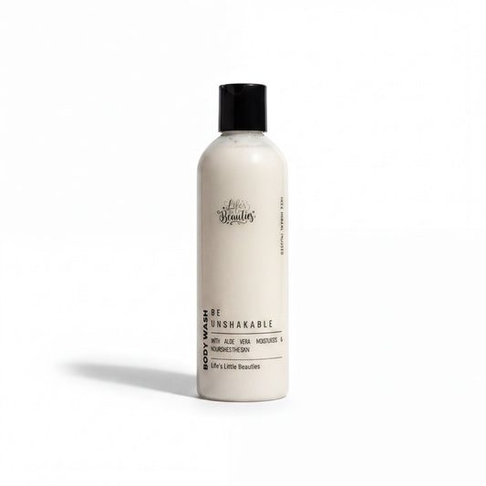 A bottle of body wash with a white label that reads "Be Unbreakable" and "Body Wash with Aloe Vera, Nourishing & Nourishing The Skin".