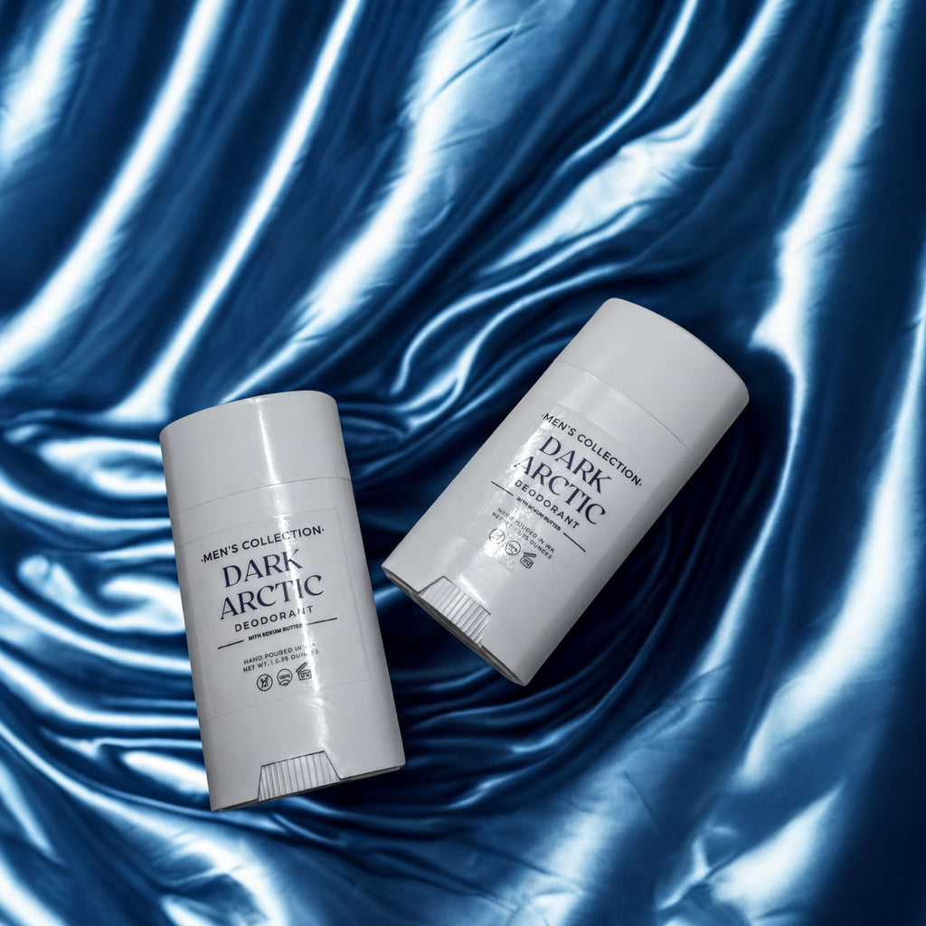 Two deodorant sticks are placed on a blue textured surface.