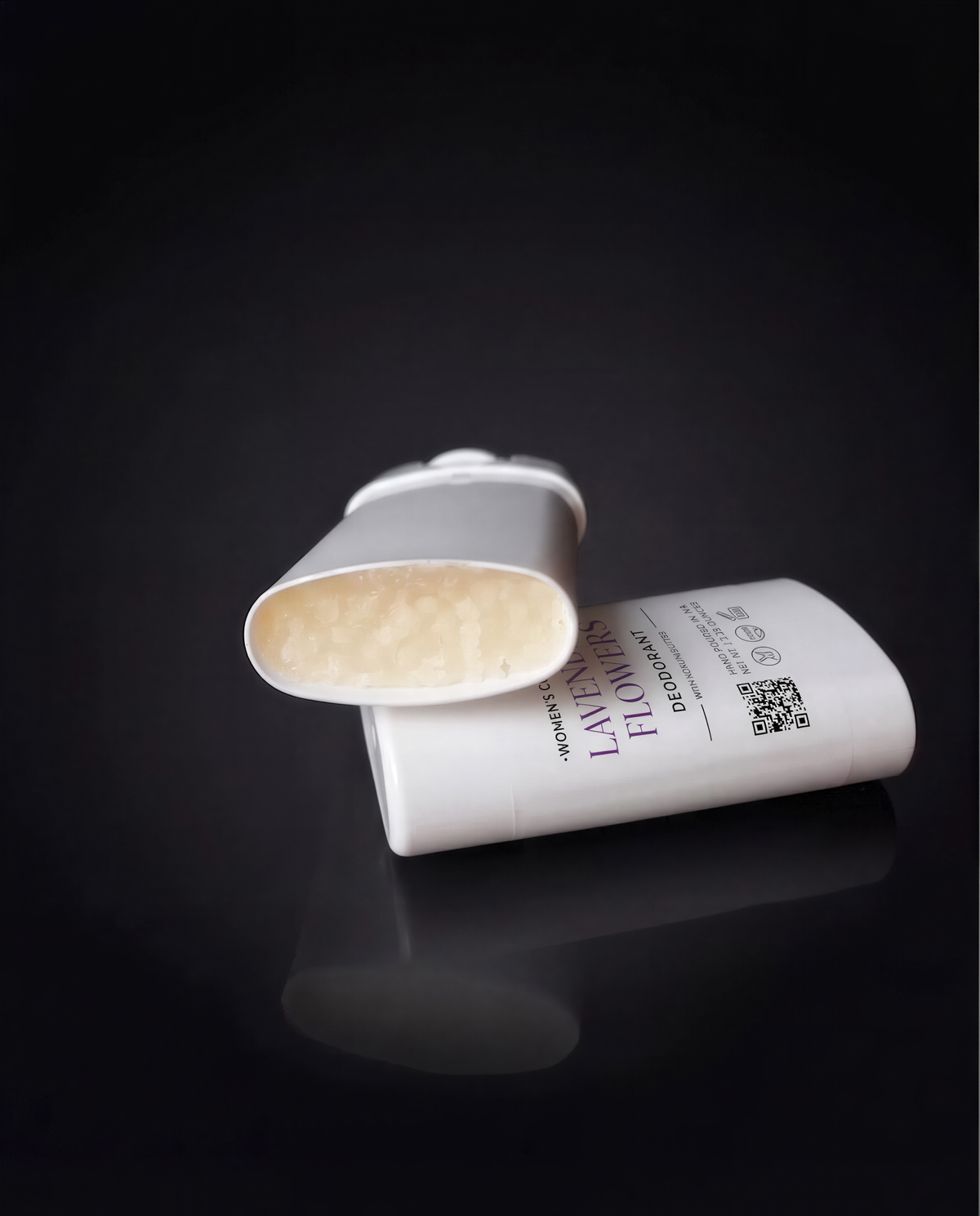 A white deodorant stick with a label that reads "LAVANDA FLOWERS" is shown against a dark background.