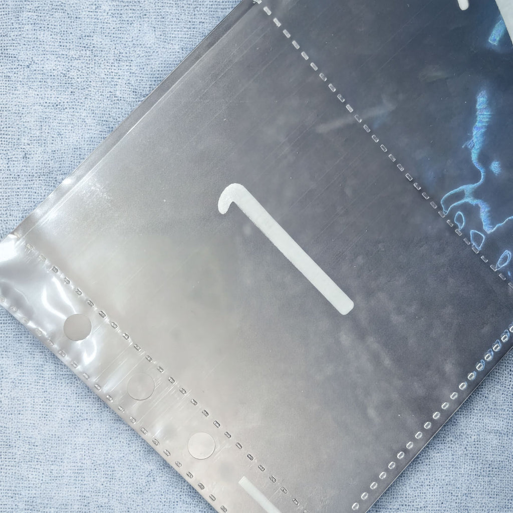 a close-up view of a metallic surface with a white number 1 visible on it.
