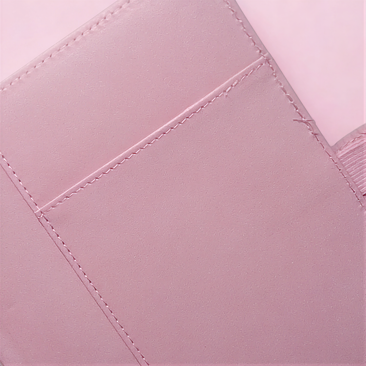Soft pink quilted fabric with delicate stitching, natural texture for handmade beauty products.