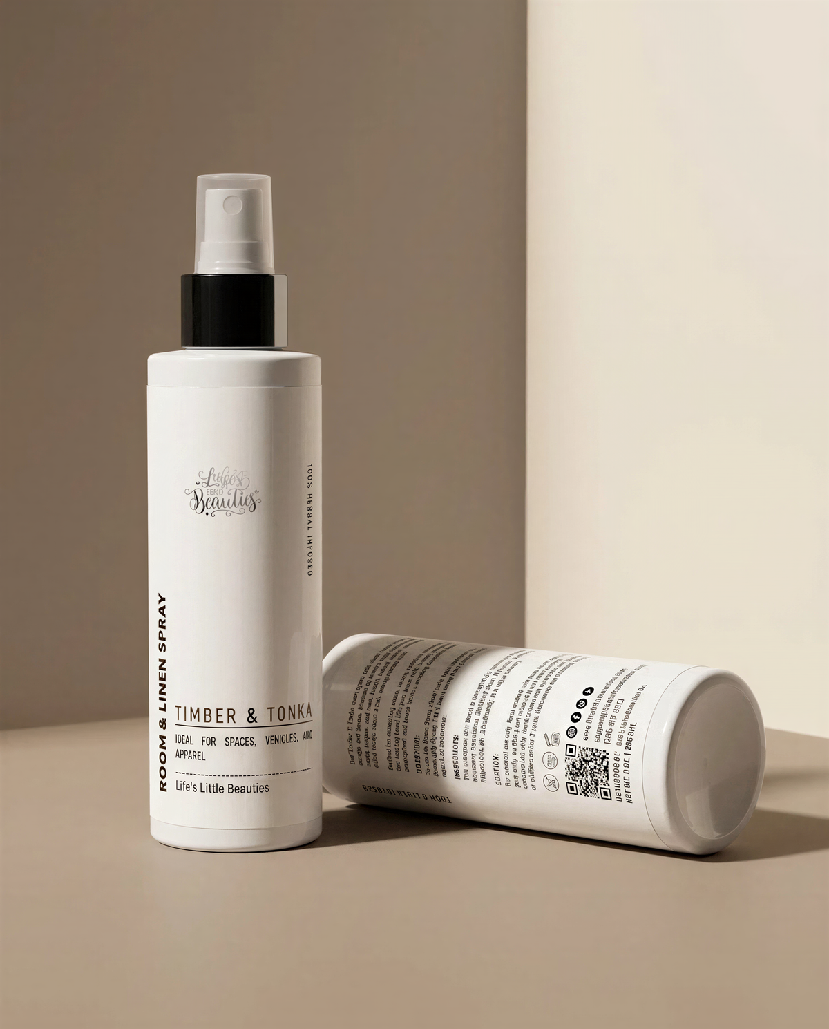 two bottles of "Lets Linnen Spray" on a beige background.