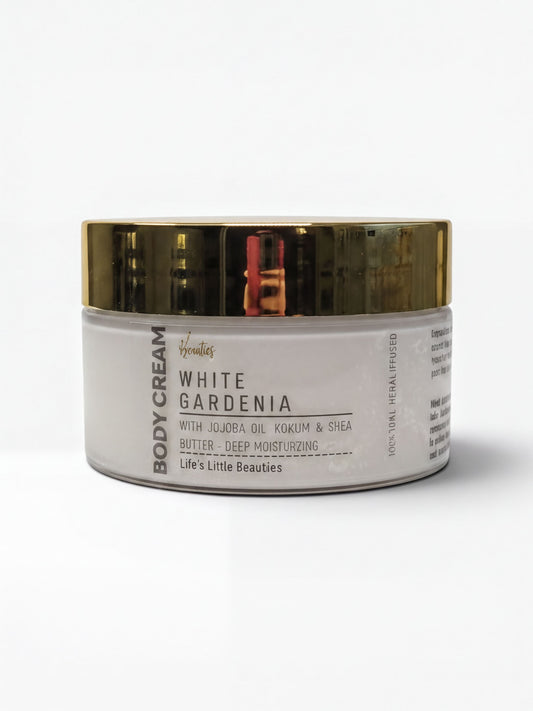 A jar of body cream with a white and gold color scheme.