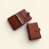 Two brown leather wallets are shown on a light background.