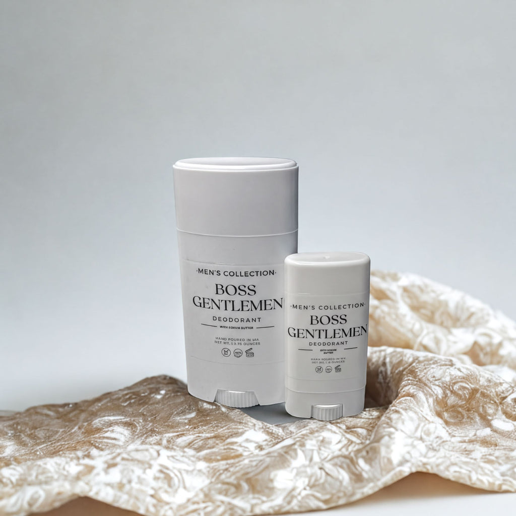 Two white deodorant sticks from the "Men's Collection" are placed on a beige fabric with a floral pattern.