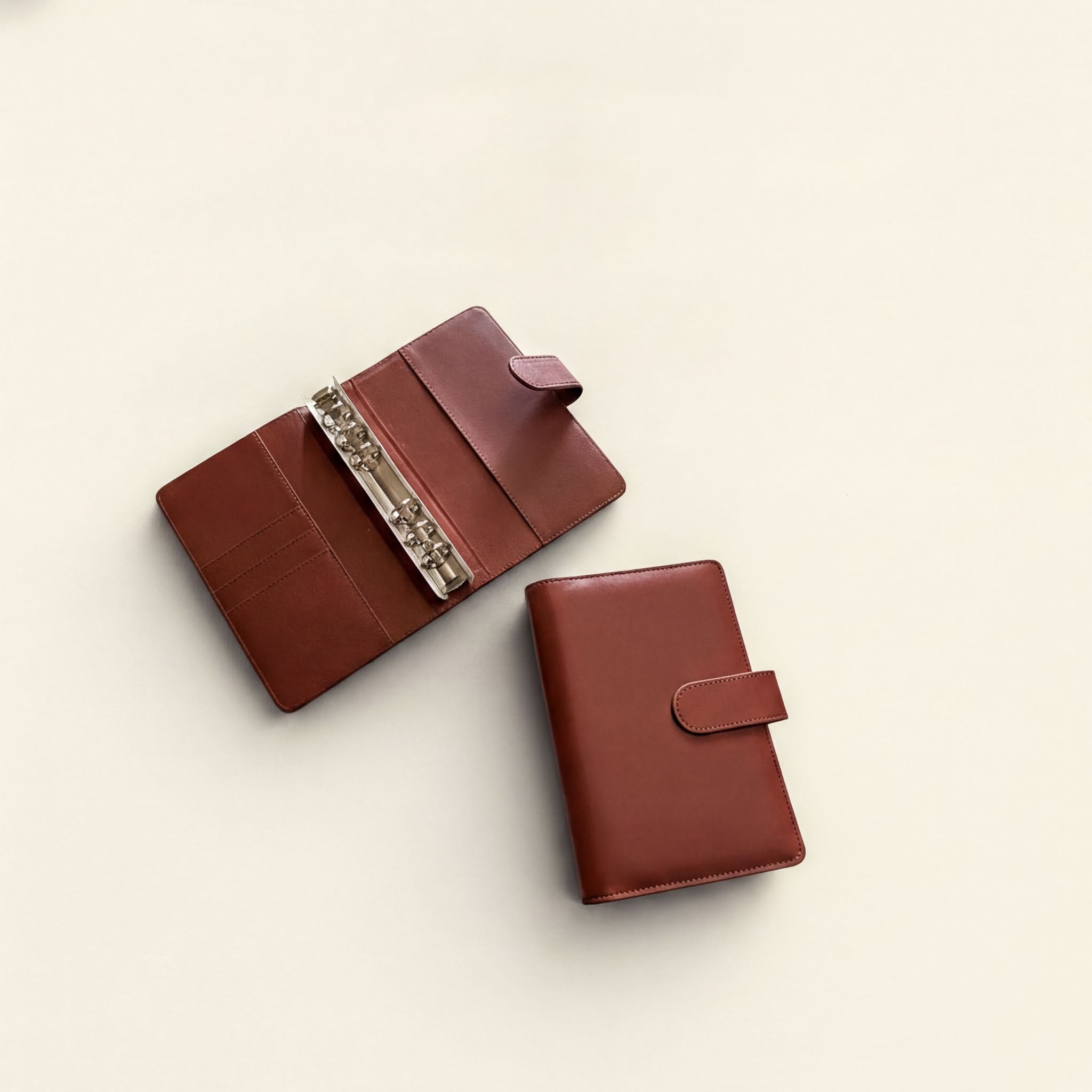 Two brown leather wallets are shown on a white background.