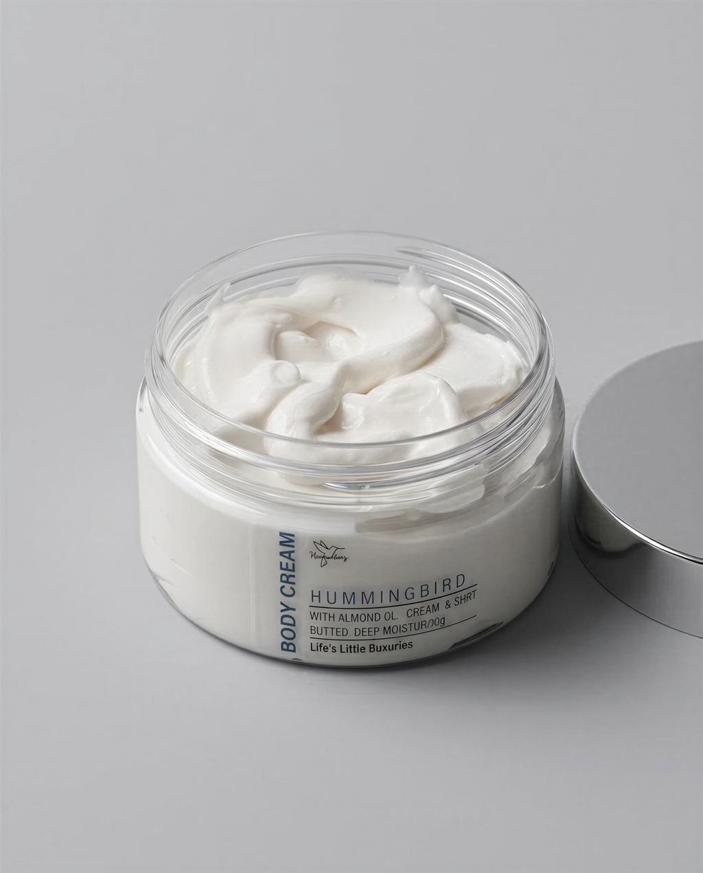 A jar of body cream with a lid, containing a white, creamy substance.
