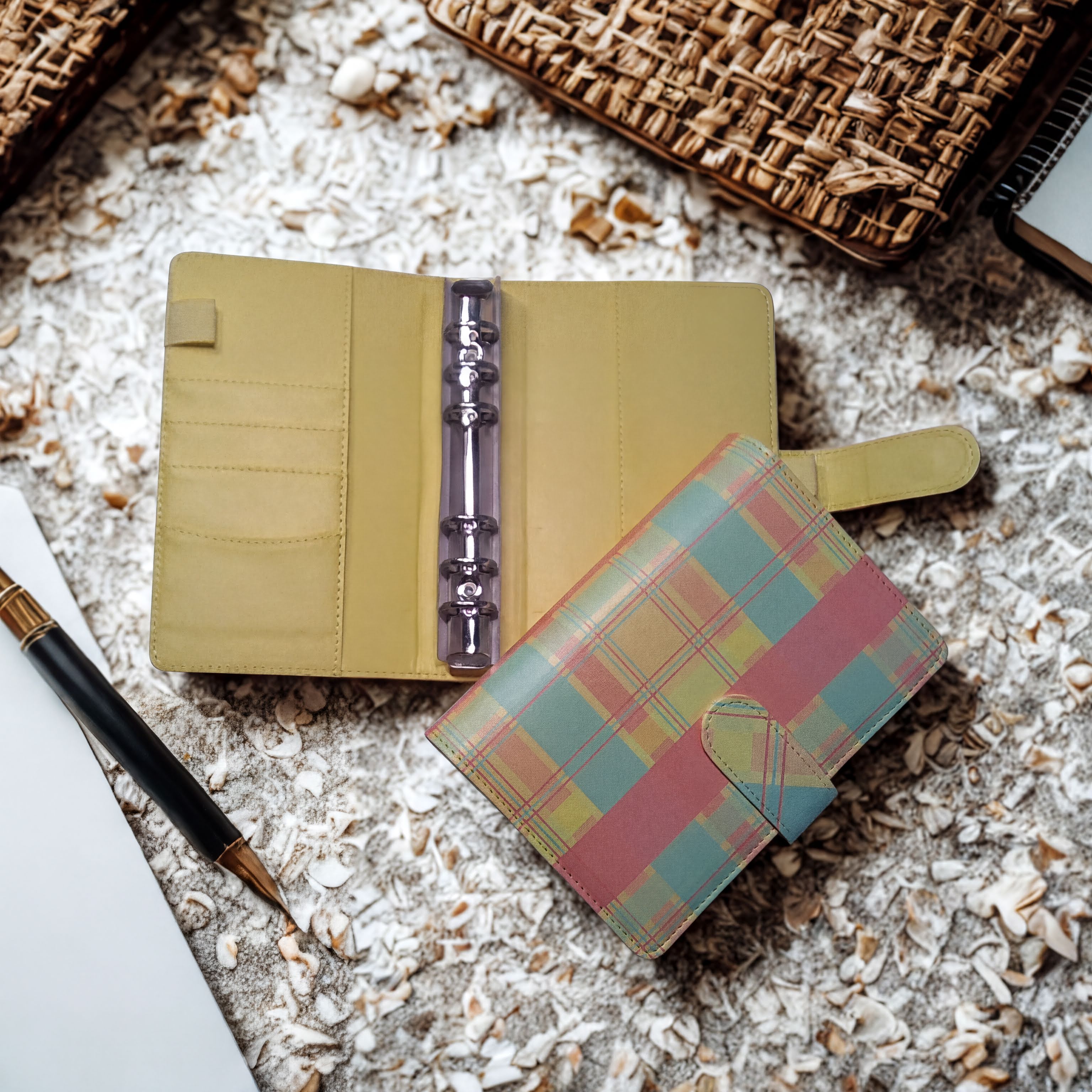 Plaid patterned notebook and pen on oatmeal background, natural ingredients theme