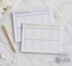 two weekly to-do lists on a marble surface, with a pen and a flower nearby.