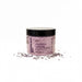 A jar of lavender bath salt surrounded by scattered lavender petals on a white background.