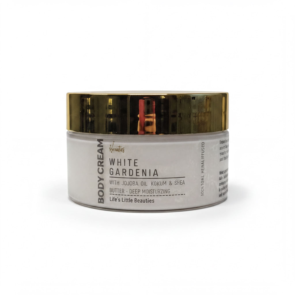 A jar of "White Gardenia Body Cream" with a gold lid, featuring a white label with black text.