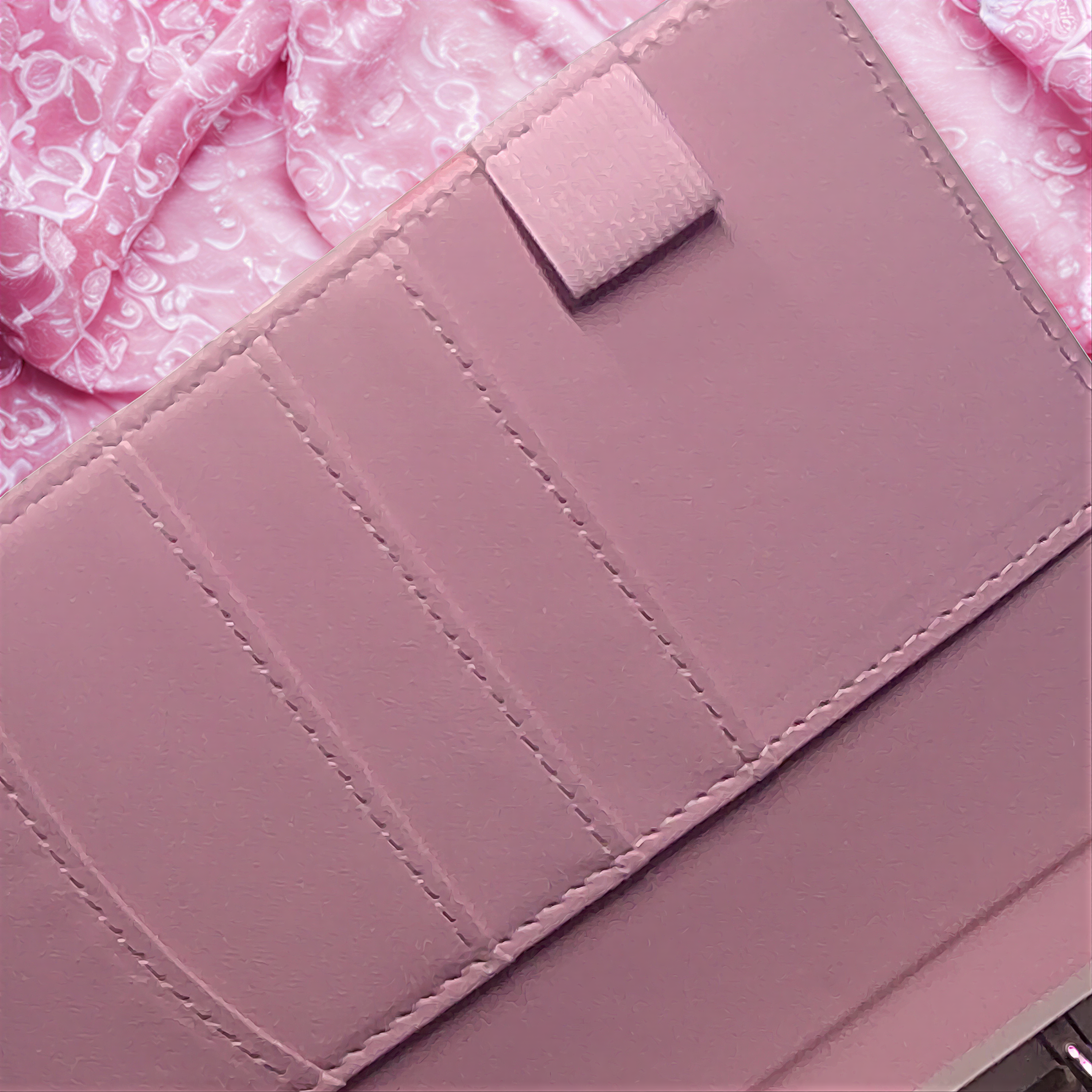 Pink quilted soap bar with decorative stitching, nestled on floral fabric