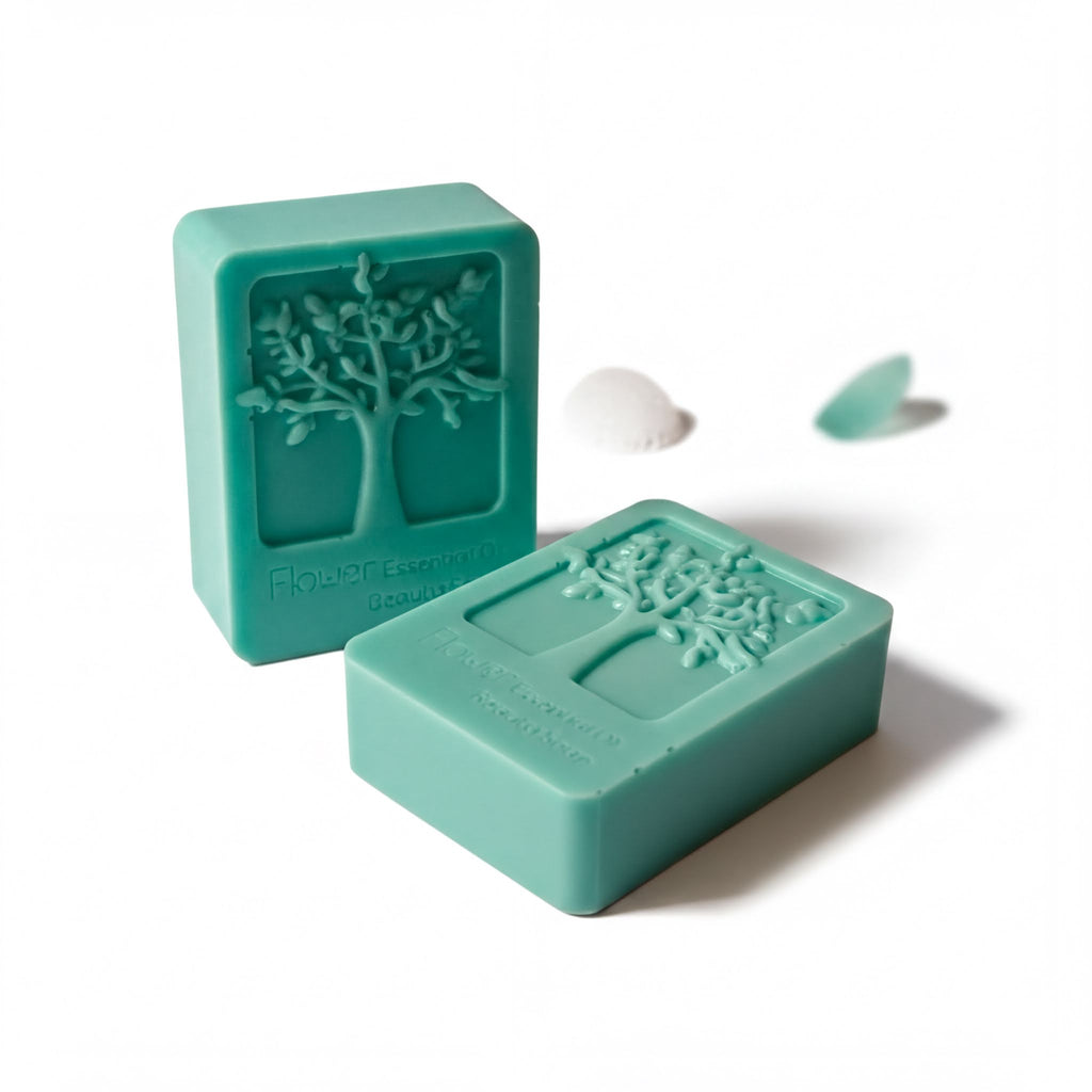 two green rectangular soap bars with tree designs on them, placed on a white background.