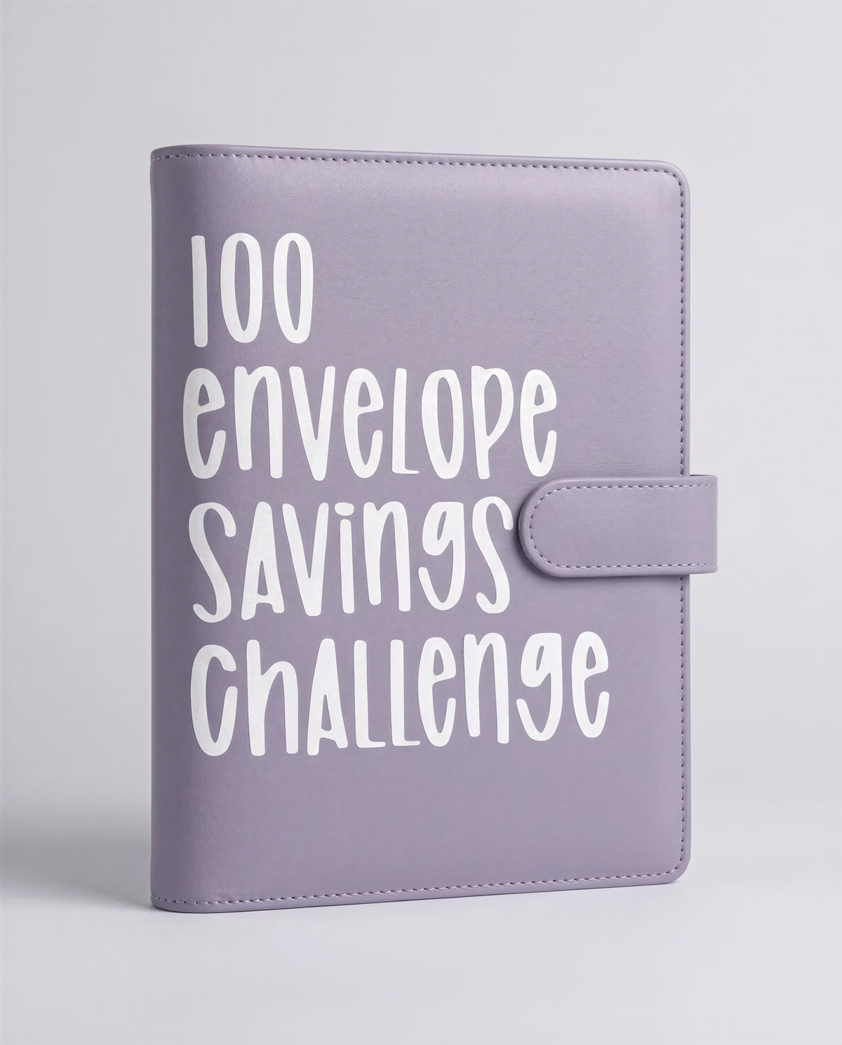 A purple leather-bound notebook or planner with the text "100 envelope savings challenge" printed on it.