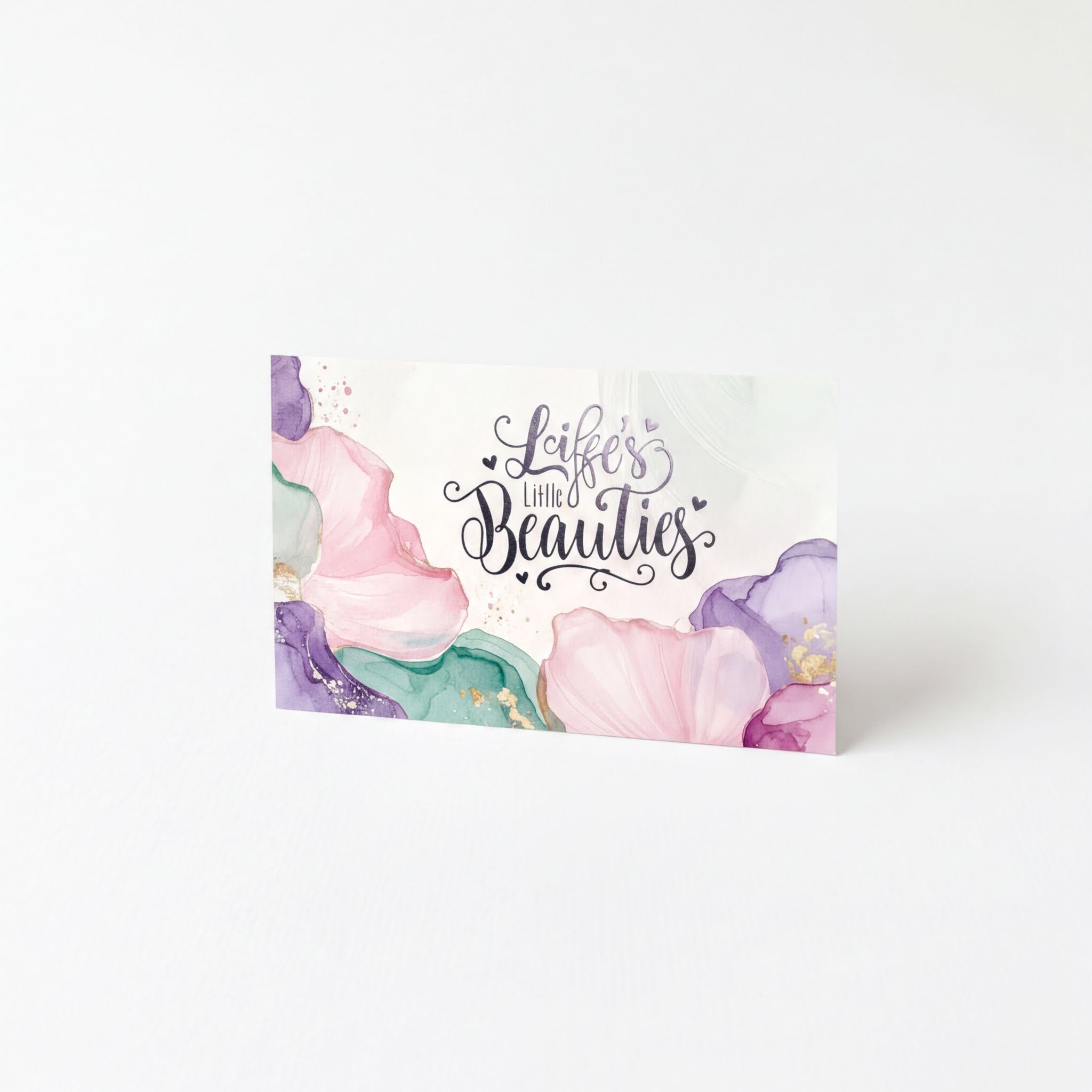 Life's Little Beauties card with watercolor flowers and elegant script, featuring natural beauty products
