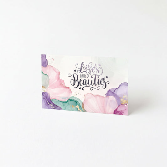 A card with a floral design and the text "Life's little beauties" written on it.