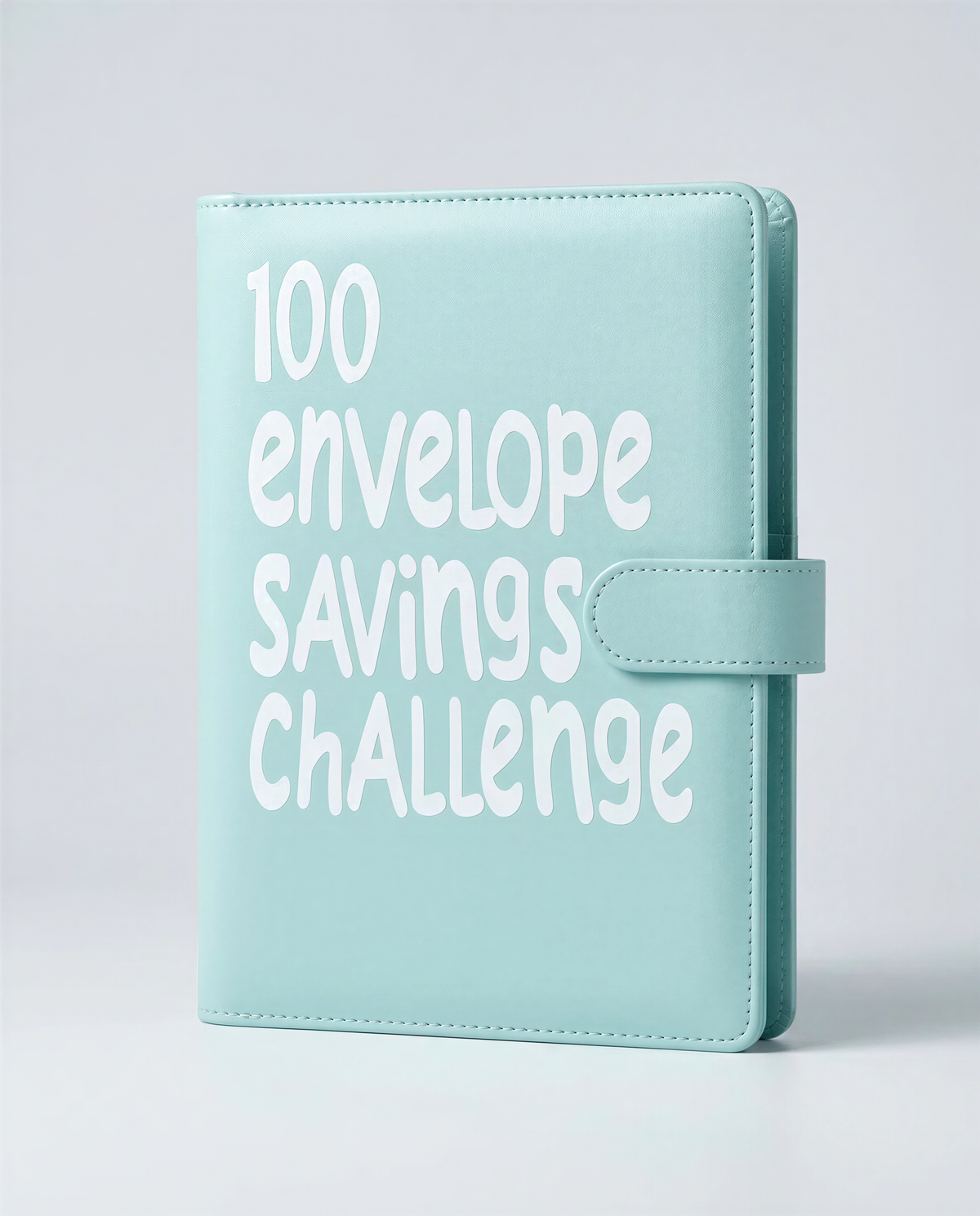 A light blue leather-bound notebook or planner with the text "100 envelope savings challenge" printed on it.