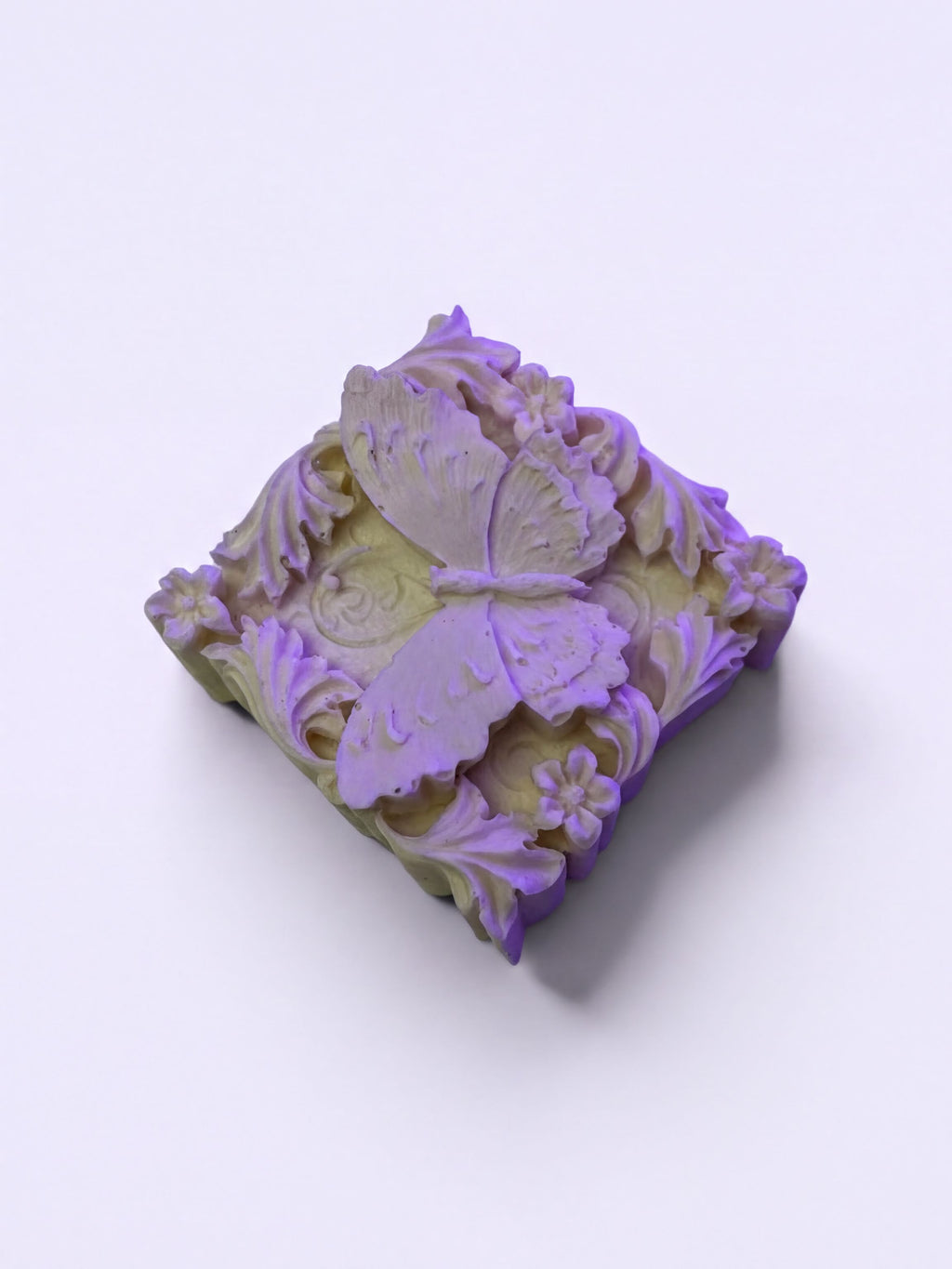 A decorative soap with a butterfly design on it.