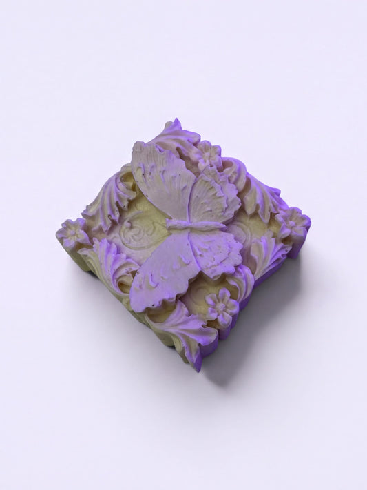 A decorative soap with a butterfly design on it.